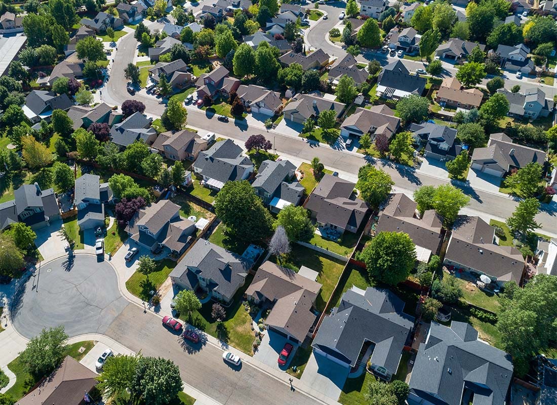 Marysville, OH - Aerial View of a Quiet Suburban Neighborhood with Homes Surrounded by Green Trees on a Sunny Day